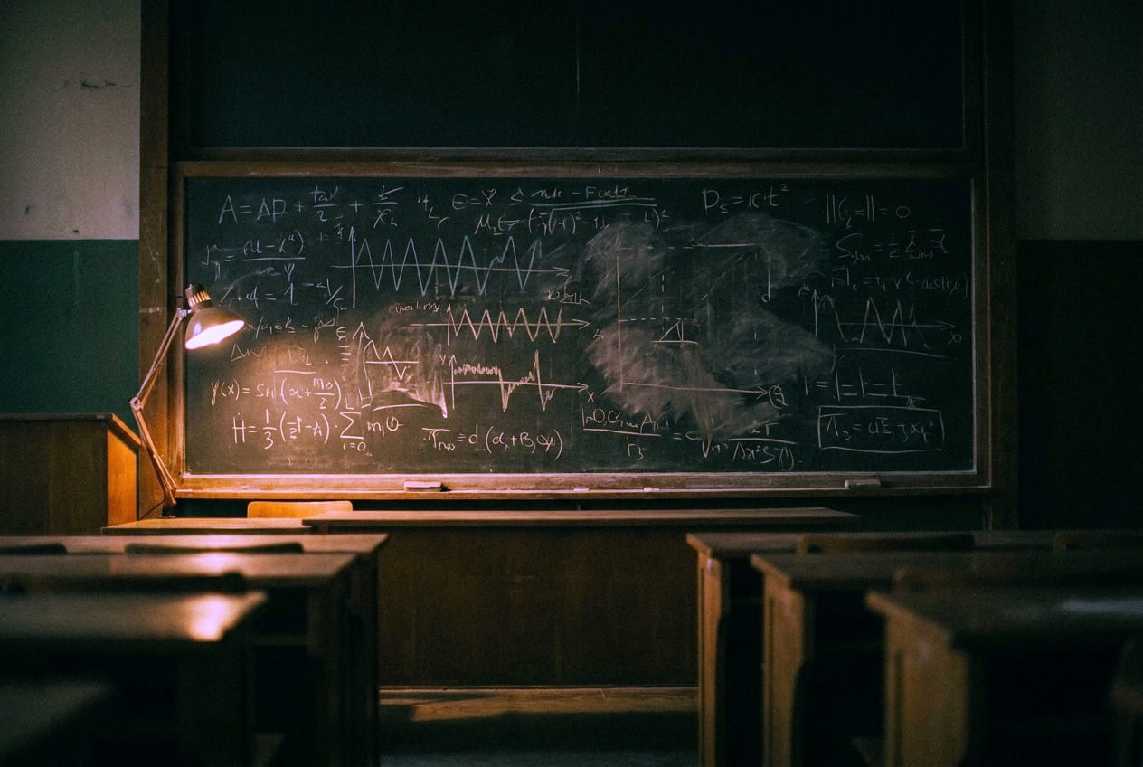 A whiteboard filled edge to edge with dense handwritten mathematics and signal diagrams.